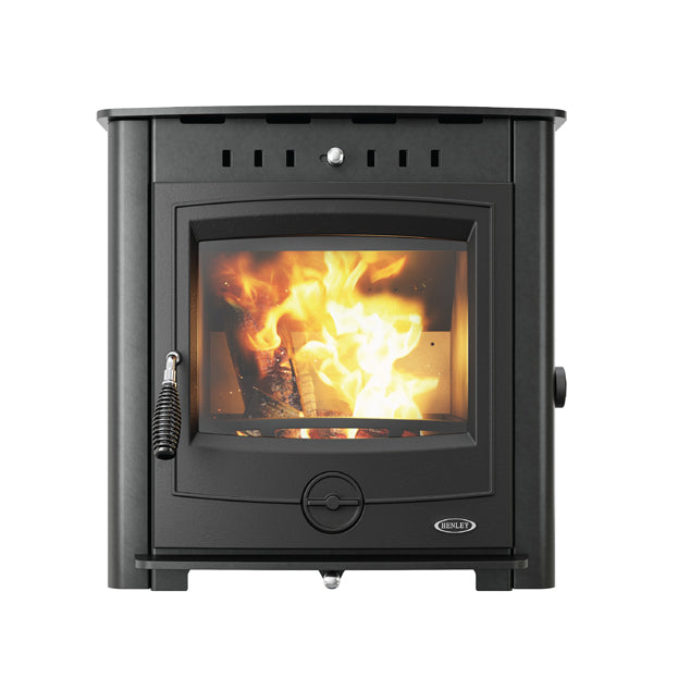 Black inset wood-burning stove with roaring fire and glass front door displaying flames and burning logs